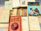 several books are stacked on top of each other on a table