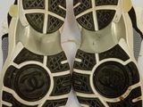 pair of black and white sandals on a white table