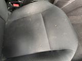a picture of a car seat with a small yellow dot in the middle of the seat