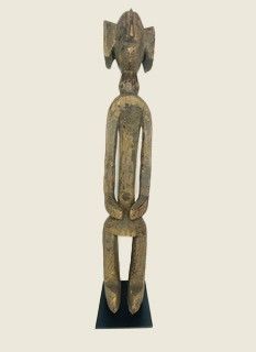 statue of a woman sitting on top of a black base