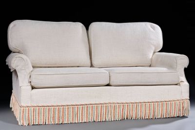 a white couch with a striped skirt on it