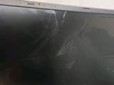 a broken screen of a laptop computer on a table