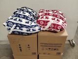 two boxes of blankets on a pallet in a room