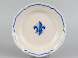a blue and white plate with a fleuron design on it