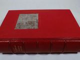 a red book sitting on top of a white table