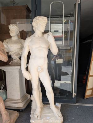 a statue of a man that is standing in front of a glass door