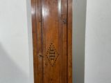 an old wooden grandfather clock sitting in the corner of a room