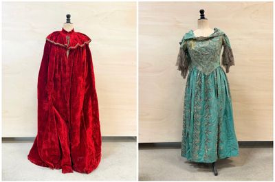 three dresses are displayed on a mannequin stand in a room