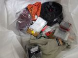 a bag full of items that are sitting on a bed