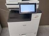 a photo of a multi - function printer with a tablet on top of it