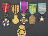 an assortment of medals including a star, a medal, a medal, a medal, a medal, a medal, and a medal