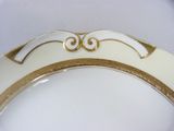 a white and gold plate with gold trim on it