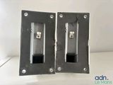 two pieces of metal on a table with a white background