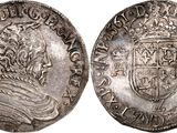 a silver coin with an image of a man in a crown on it