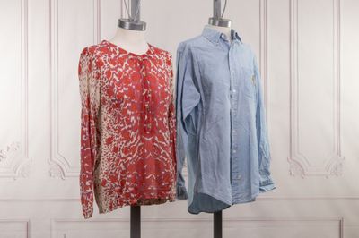 two women ' s shirts on a mannequin stand in front of a white wall