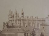 a black and white photo of a large castle in the middle of a town