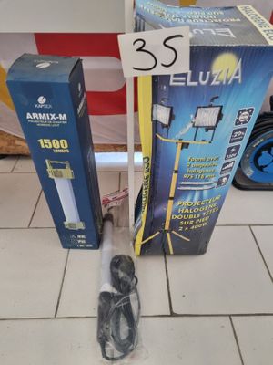 two boxes of electronic equipment sitting on a tiled floor