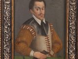 portrait of a man in a brown coat holding a gun