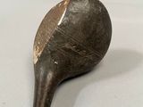 a wooden paddle that is sitting on a table