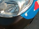 a close up of a car ' s headlight with a red, white, and blue design