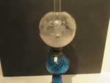 un vase en verre orné d'un visage, posé sur une table