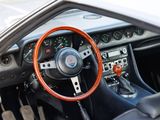 a steering wheel and dashboard of a sports car