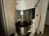 a mixer that is sitting on a stand in the kitchen