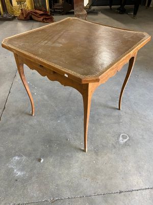 a small table with a wooden top on a concrete floor