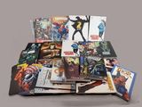 a pile of comic books sitting on a table
