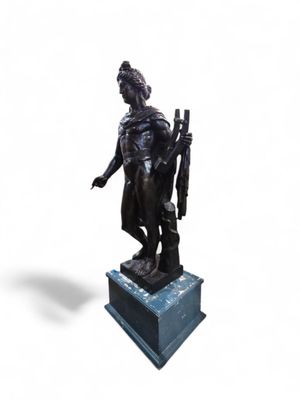 statue of a man with a gun on a pedestal