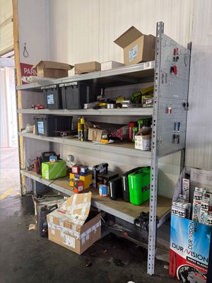 many boxes and boxes on the shelves in the garage