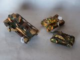two toy tanks sitting next to each other on a table