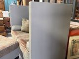 two chairs and a ottoman in a room