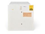 a small white refrigerator with a sticker on it