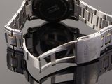a close up of a wrist watch on a reflective surface