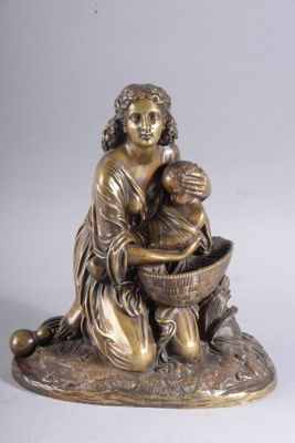 bronze figurine of a woman washing a child in a bowl
