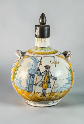 a small vase with a painting on it sitting on a table