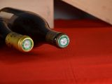 two bottles of wine sitting on a red table