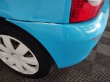 a close up of a blue car with white rims