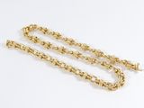 a close up of a gold chain on a white background
