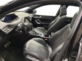 the interior of a car with the door open and the driver ' s seat down