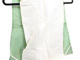 a green and white towel hanging on a black hanger