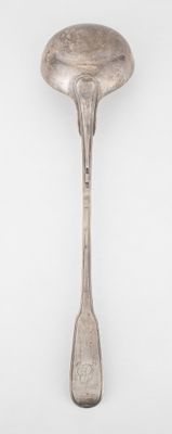 a spoon with a spoon rest on it on a white surface