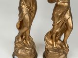 pair of antique bronze figurines of a boy and a girl