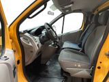 a yellow truck with a black seat in the back of it