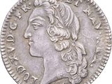 a close up of a coin with a woman ' s face on it