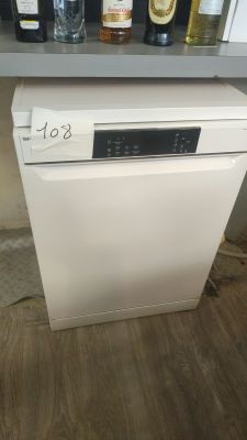 a white dishwasher sitting on a counter in a kitchen