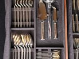 many silverware in a wooden box on a table