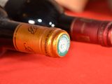 two bottles of wine sitting on a red table