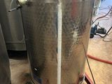 a large metal pot that is sitting on a stand